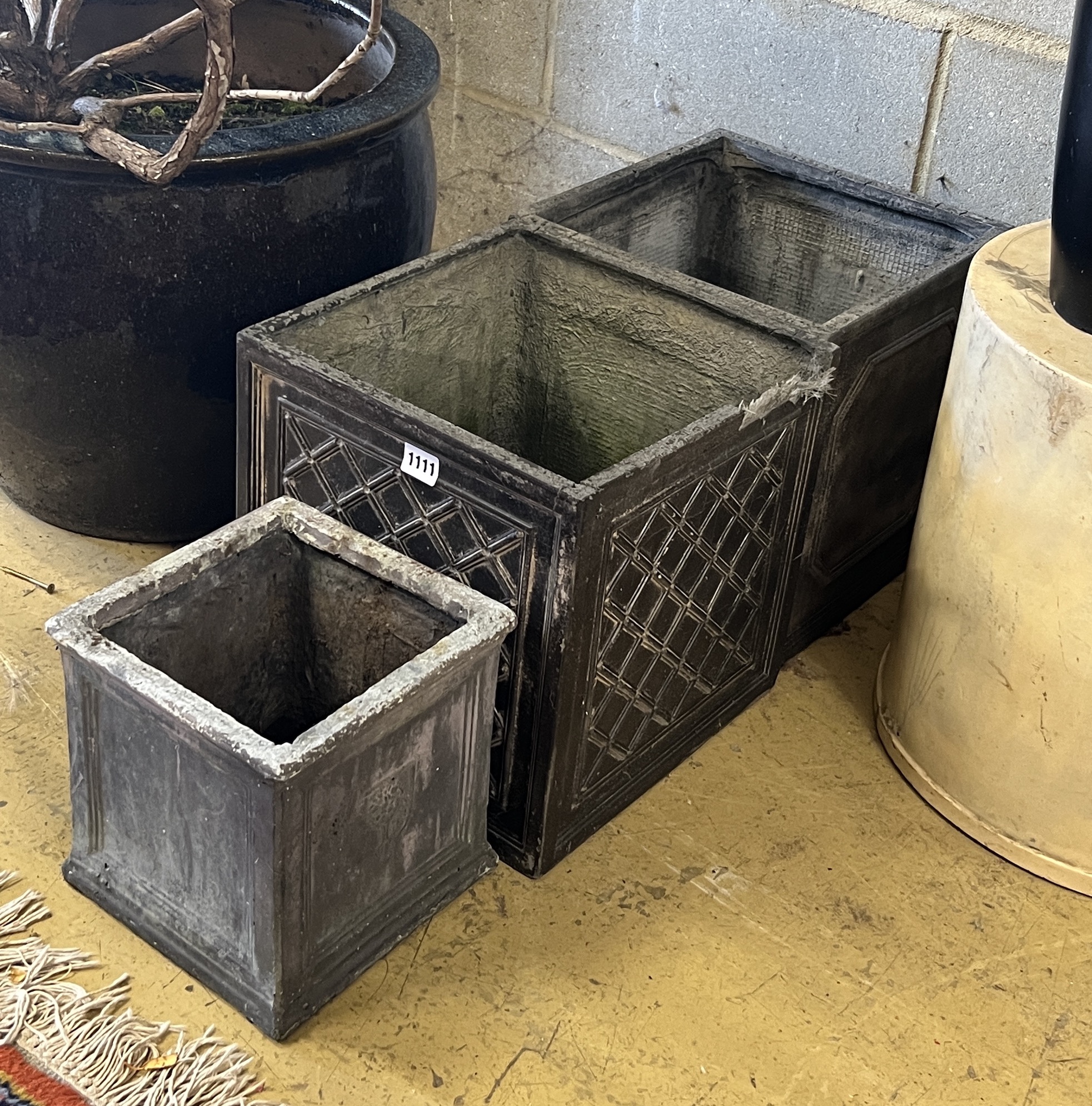 Three composition faux lead square garden planters, larger width 32cm, height 32cm